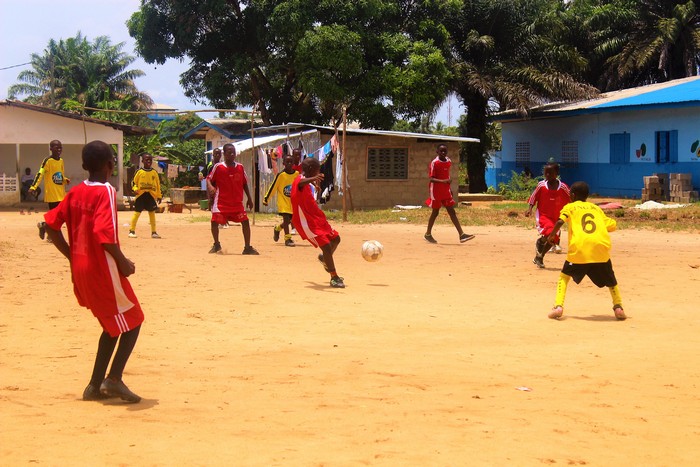 Teenagers playing football